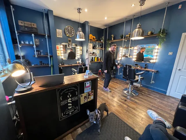 The owner and the shop’s French bulldog by the chairs