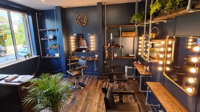 Inside Butler’s Barbering — navy walls, bulb mirrors and leather chairs